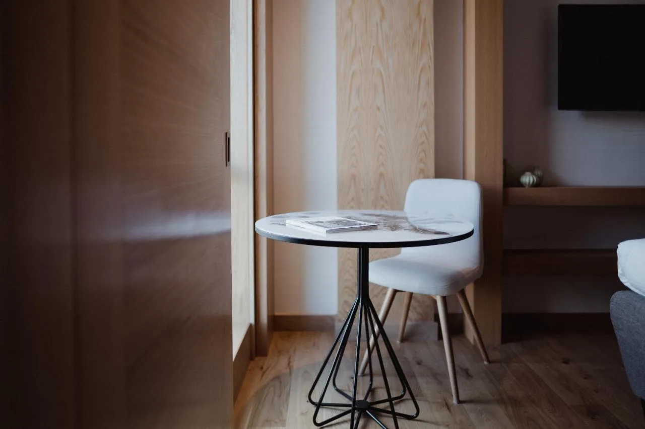 a small table and a chair in a room at Market Street hotel in Edinburgh