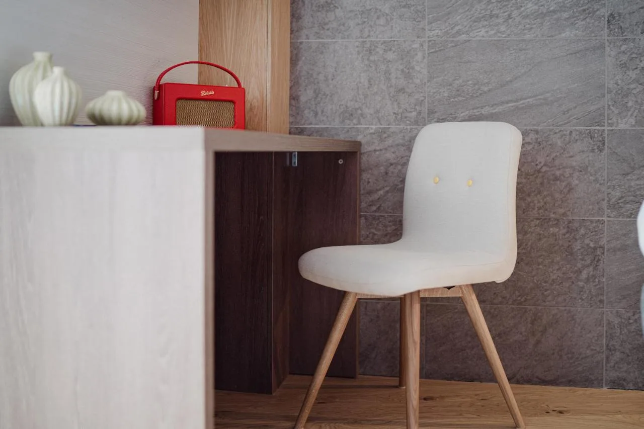 a white chair sitting next to a desk at Market Street hotel in Edinburgh